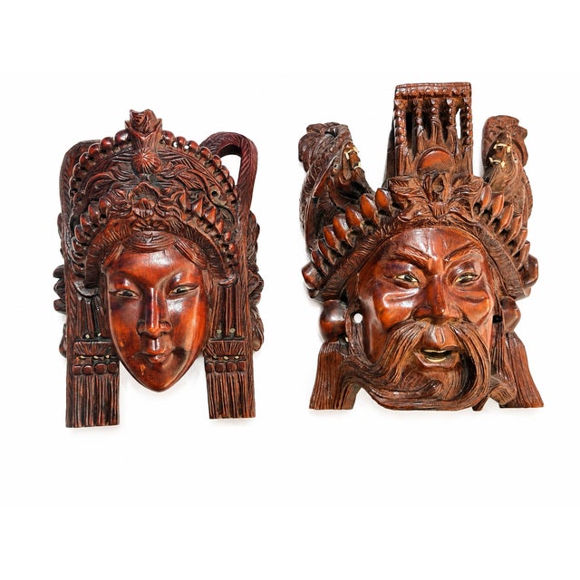 A richly detailed pair of vintage Indonesian hand-carved wood wall masks, likely Balinese and believed to depict Rama and...