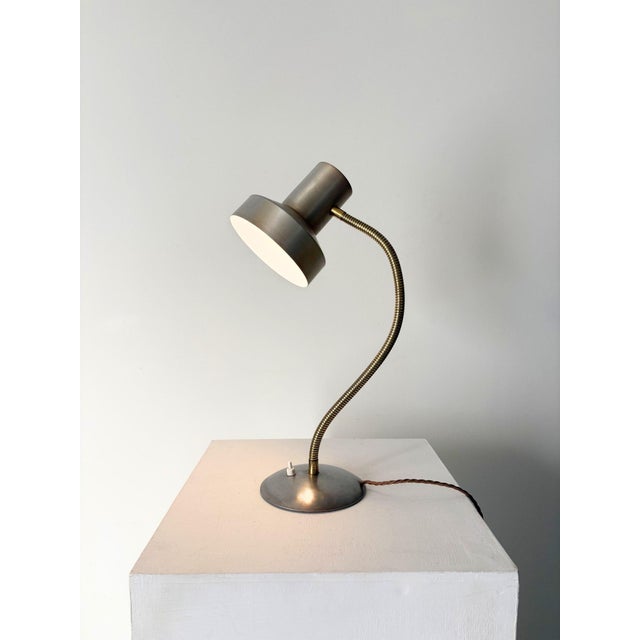 A sleek vintage side light or desk lamp with integrated brushed aluminium shade, flexible goose neck in brass, and a...