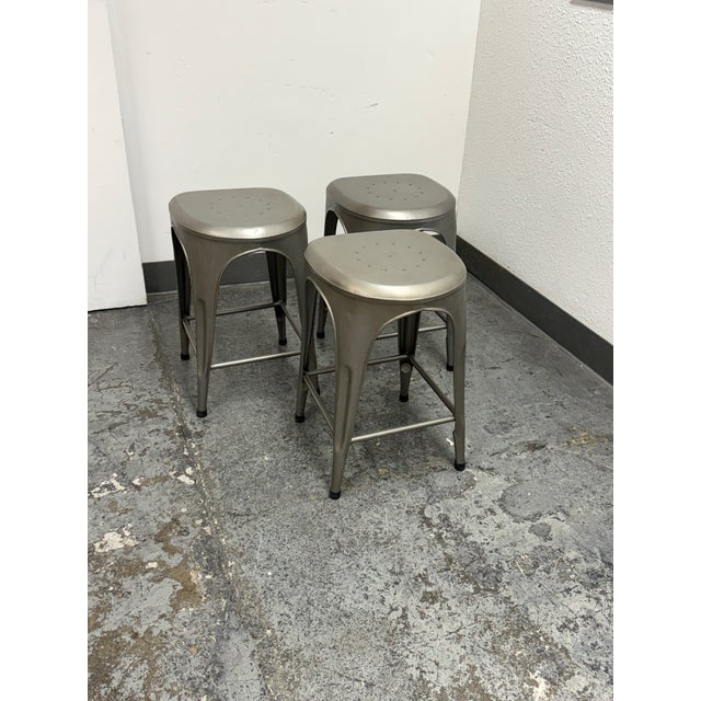 Design Plus Gallery presents a Set of Three Remy Backless Counter Stools from Restoration Hardware. The Remy collection...