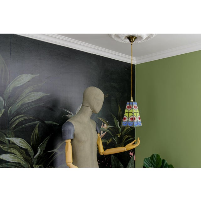 Mid-century modern blue, yellow, white, and red stained glass pendant light fixture from circa the 1970s, signed by the...