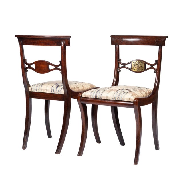 Pair of English Regency Period faux rosewood painted beechwood Klismos side chairs inlaid with pierced brass...