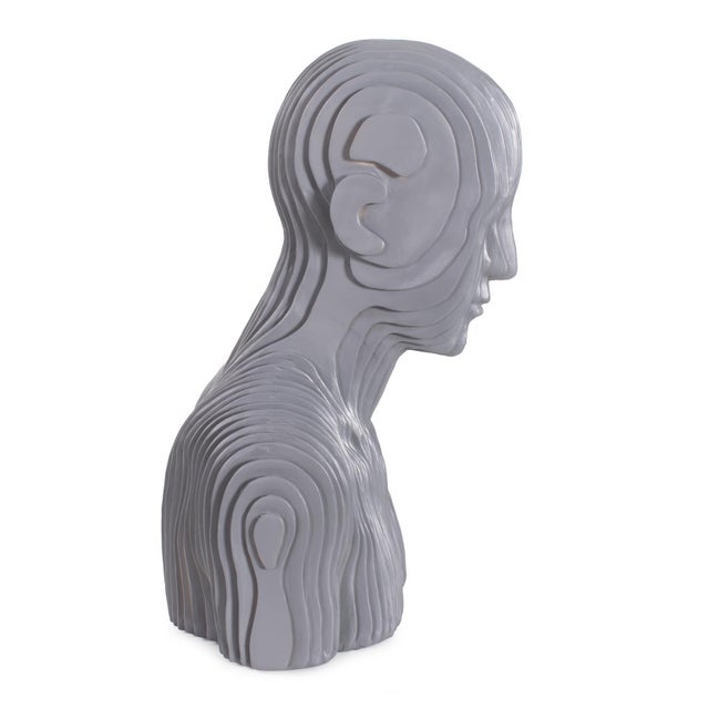 This bold sculpture deconstructs the human form with layered, vertical segments, offering a fresh and modern perspective....
