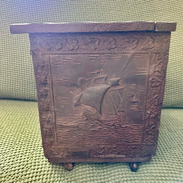 Antique solid wood box with decorative brass (or copper) cladding on the exterior walls that are embossed with a a...