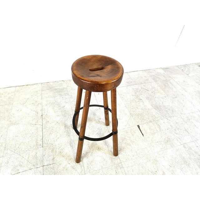 Beautiful hand made mid century oak bar stool with a steel ring foot rest. Nicely finished seat with handy handle cut out....
