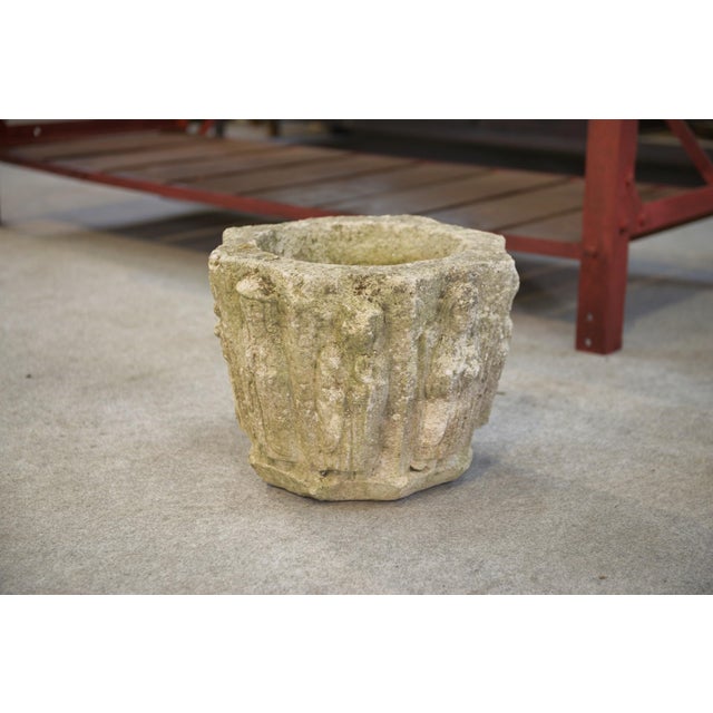 A 1950s reconstituted stone planter with a compact and highly sculptural form. The body features a vertical relief...
