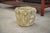 A 1950s reconstituted stone planter with a compact and highly sculptural form. The body features a vertical relief...