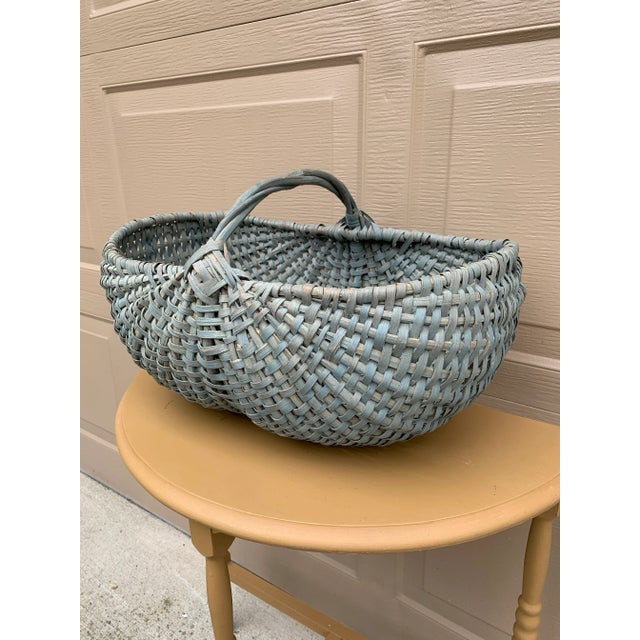 A beautifully woven early 20th century American splint oak basket painted in soft pale blue tones with a tightly...