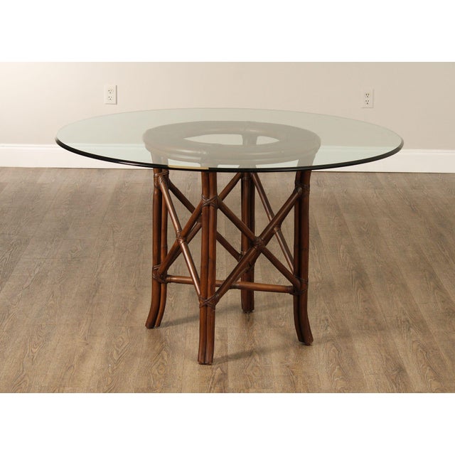 High Quality Hollywood Regency Style Dining Table Featuring A Round Glass Top Supported By A Natural Rattan Frame With...