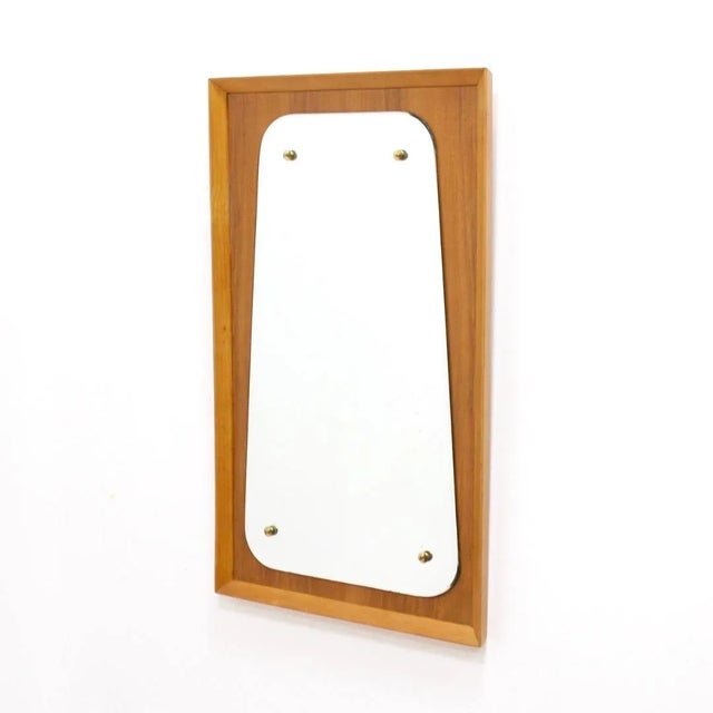 This mid-century wall mounted vertical mirror was made in England. Produced in the 1960s mirror is mounted on beautiful...