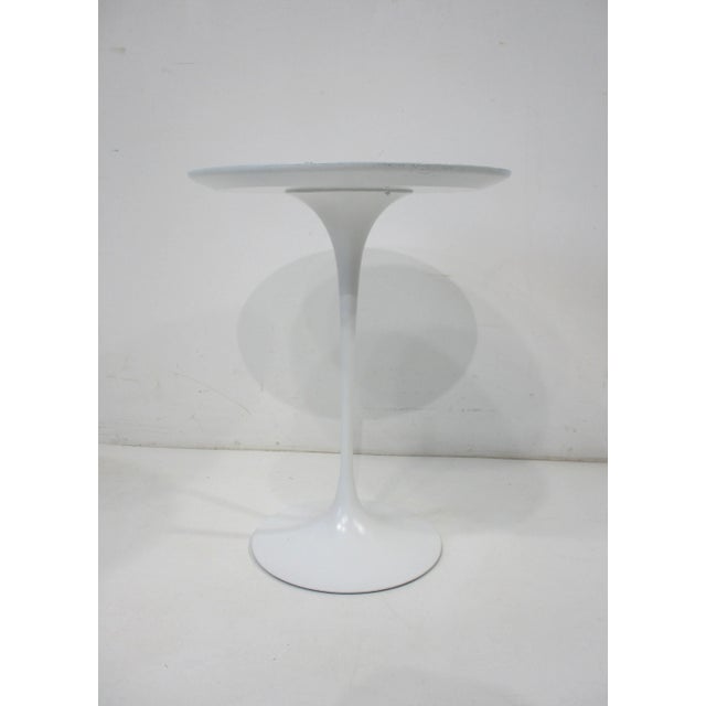 A very early steel based tulip side table with round white Laminate top and matching color base deigned by Eero Saarinen ....