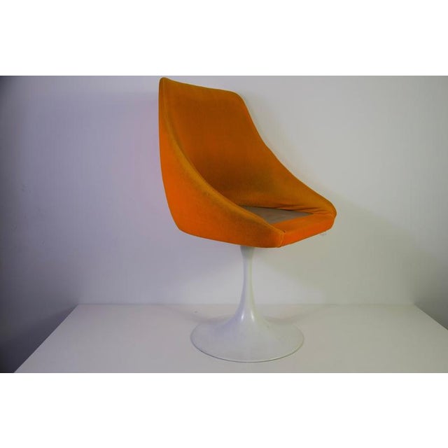 Orange tulip armchair in the style of Knoll, 1970s. This striking vintage chair features a sculptural upholstered shell...