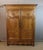 A carved and molded light oak wardrobe dating from the 18th century. It opens with two doors; the interior is fitted with...