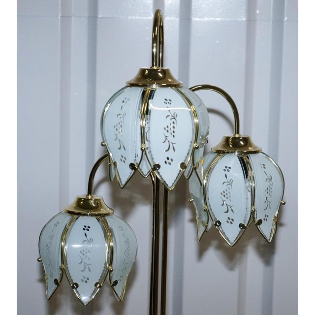 This elegant vintage floor lamp embodies classic Hollywood Regency glamour, combining a polished brass base with a...