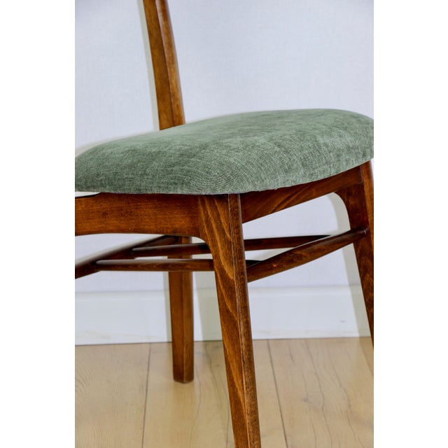 Hałas vintage chair in green with a wooden backrest. A completely restored original chair designed by Rajmund Hałas in the...