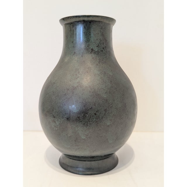 Japanese vase with a high-relief peony motif executed in gold and silver mixed metals over a dark patinated ground....