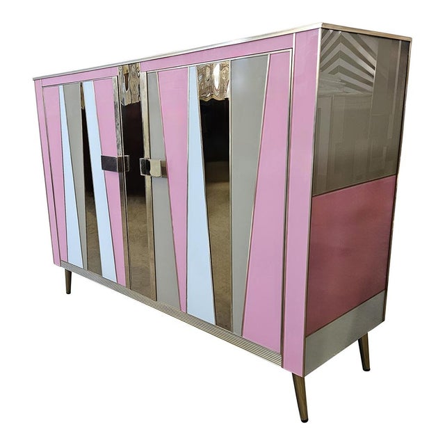 Sideboard with two doors, entirely handmade, with wooden structure and covered in pink and gray Murano glass; enriched...