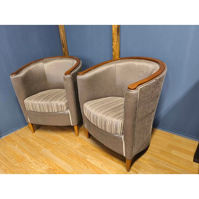 The pair of armchairs shown in the pictures were probably made around the 1930s. They are Art Deco style pieces that carry...