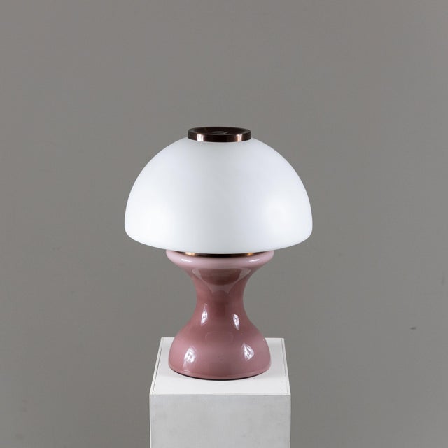 Table lamp made in Italy in the 1970s. Base in antique pink glass, upper diffuser in satin white glass and details in...