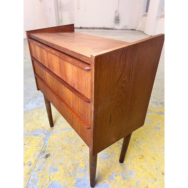 This small teak chest of drawers from Denmark is a prime example of Scandinavian interior design in a compact format....