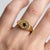 Embrace a celestial, vintage-inspired aesthetic with a bold, modern twist. This striking signet ring features a smooth...