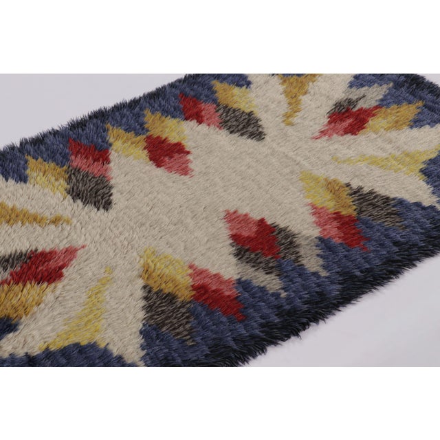 Hand-knotted in lush, high-pile wool in Sweden circa 1960-1970, this 3x5 vintage Swedish Rya rug is a bold new addition to...