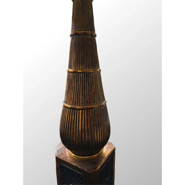 Mid century gold leaf painted lamps in working condition, black base with starburst.