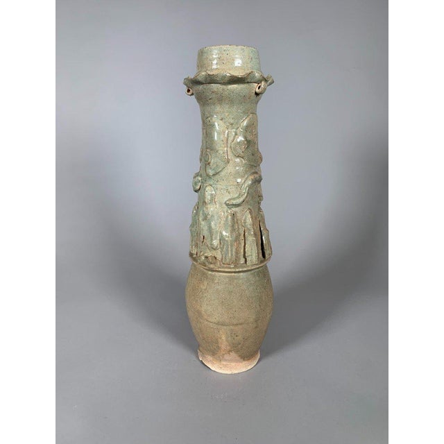 Pair of funerary urns with ovoid bodies and tall, cylindrical necks molded with a decoration of Taoist sages and coiled...