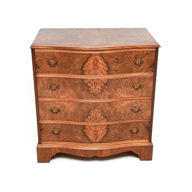 A gorgeous antique serpentine burr walnut chest of drawers in the Georgian style. This was made in England, it dates from...