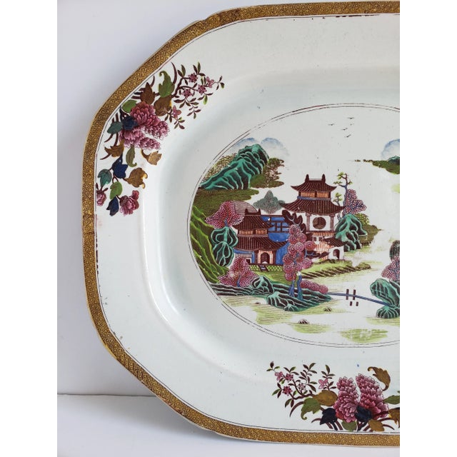 Early 19th century Mason's ironstone large platter featuring a Chinoiserie motif with pagodas around water and a fisherman.