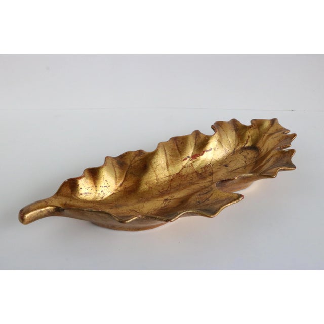 Leaf form dish from Freeman & McFarlin with an aged gold-tone finish. The bottom of this piece retains its original label.