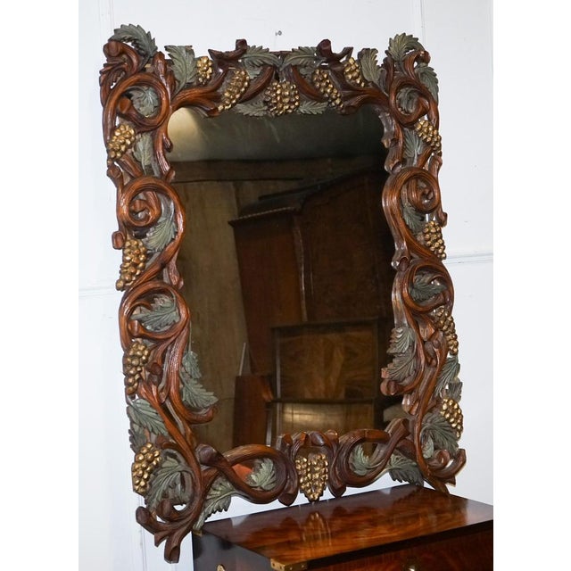 Vintage Black Forrest Style Heavily Carved Wall Mirror. It embodies the striking Black Forest style, renowned for its...