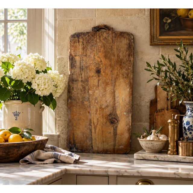 A substantial late 19th-century French bread board with the wonderfully irregular surface and mellow patina that only...