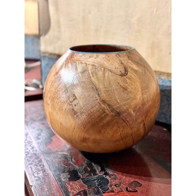 This is a beautifully elaborated and finely carved Burl vessel that has been polished to a satin smoothness and inlaid...