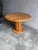 A characterful round dining table crafted from solid pine, dating from the 1970s. The design combines a generous circular...