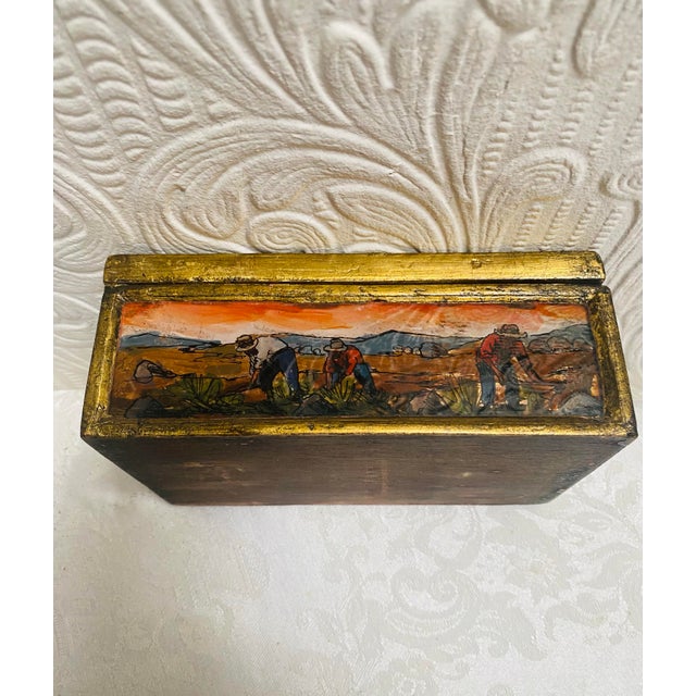 This is a beautiful gold guilt wooden box that has reverse painted glass surrounding it. That is done in the style of van...