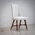 Set of six dining chairs from the 1950s featuring gently shaped frames in dark-stained wood with brass sabots. The rounded...