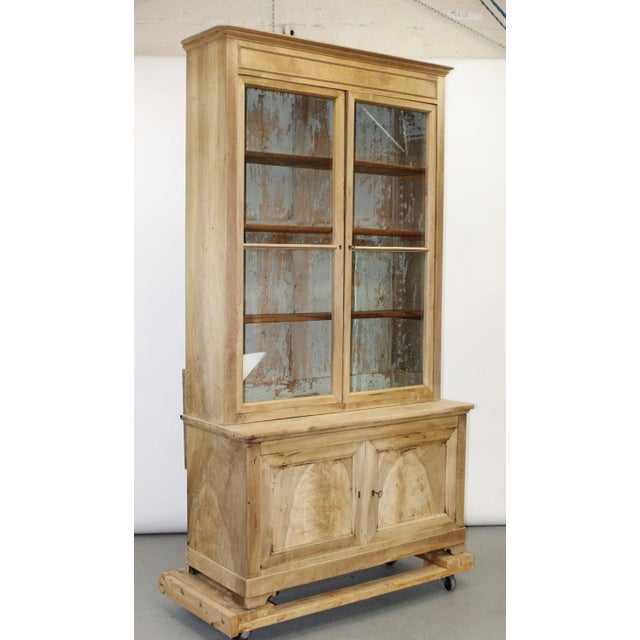 A handsome 19th century provincial step-back cupboard crafted in solid walnut, now finished in a soft bleached tone that...