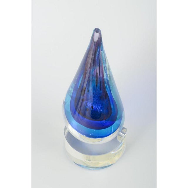 Murano Drop-shaped glass sculpture, 1970s. Handmade sculpture in clear and blue-violet glass, shaped as a drop with...