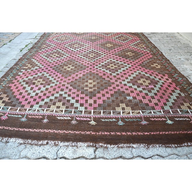 This is a vintage Turkish Anatolian kilim rug from the 1960s. The piece was hand-woven.
