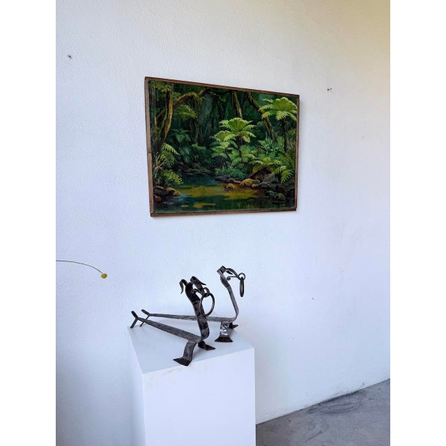 A vintage pair of handcrafted metal andirons from the 1950s. Zoomorphic, with their depiction of a dog, these andirons...