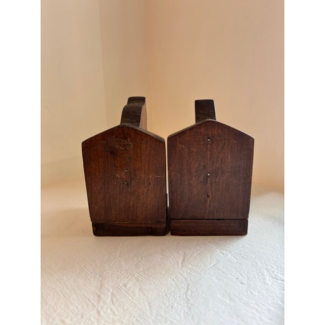 Dark stained wooden bookends carved into a horse/donkey shape Head: 3.5 x 3.5 x 6.5 Tail: 3.5 x 3.5 x 6