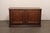 An Italian walnut credenza console from the early 19th century. This antique cabinet from Italy, a handsome and restrained...