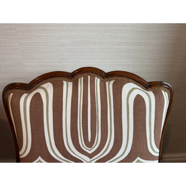 These chairs are classic French bergères, likely inspired by or originating from the Louis XV style, recognizable through...