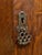 A handsome antique armoire with a tall architectural silhouette and richly figured wood grain throughout. The front is...