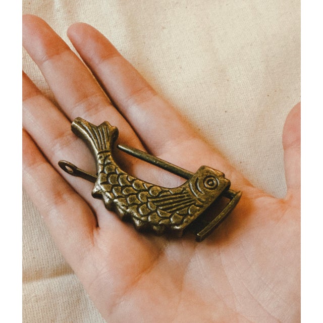 Both functional and decorative, this vintage fish shaped padlock is a charming example of everyday craftsmanship...
