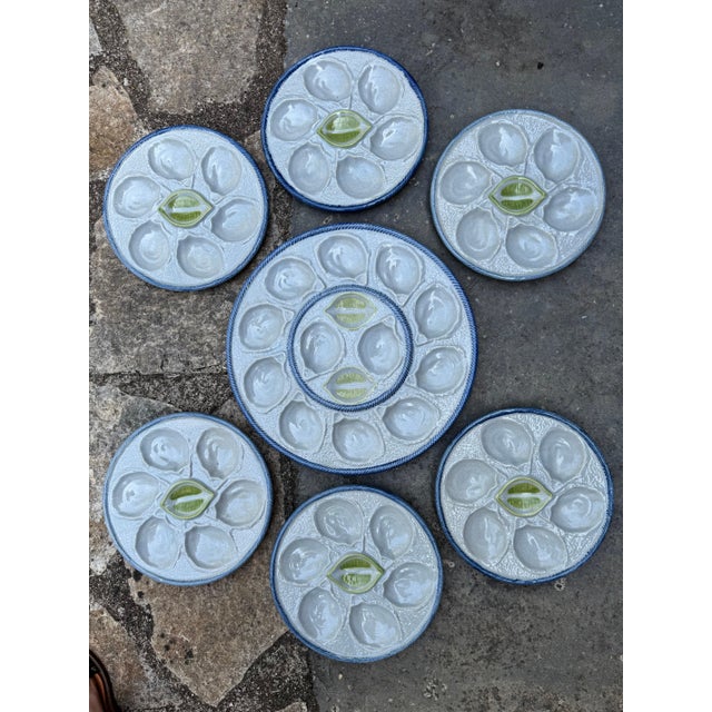 Set of 1950’s set of six oyster plates and one platter by St Clement. plate 10” dia, platter 15”dia 49-062