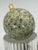 This is a unique, hand-decorated glass ornament, measuring approximately 3 inches round and surprisingly heavy for its...