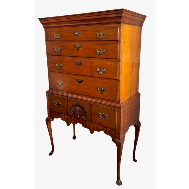 An 18th century New England Cherry High Boy. Five Drawers with one featuring a fan carved panel. Exposed Dovetails on...