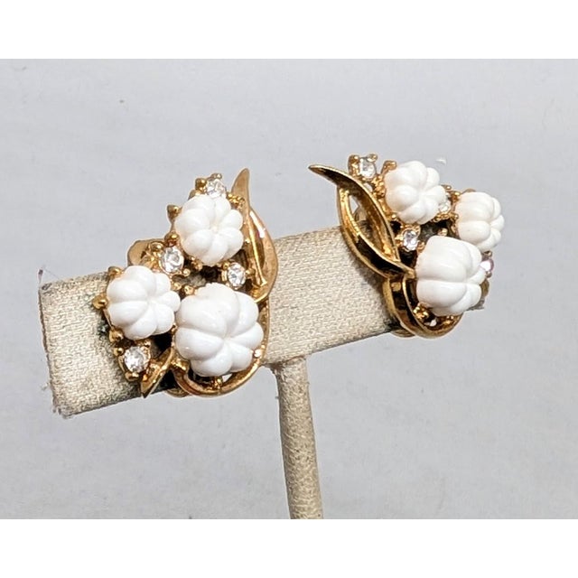 Mid to late 1950s goldtone white resin melon shaped rhinestones with clear round rhinestone accents clip earrings....