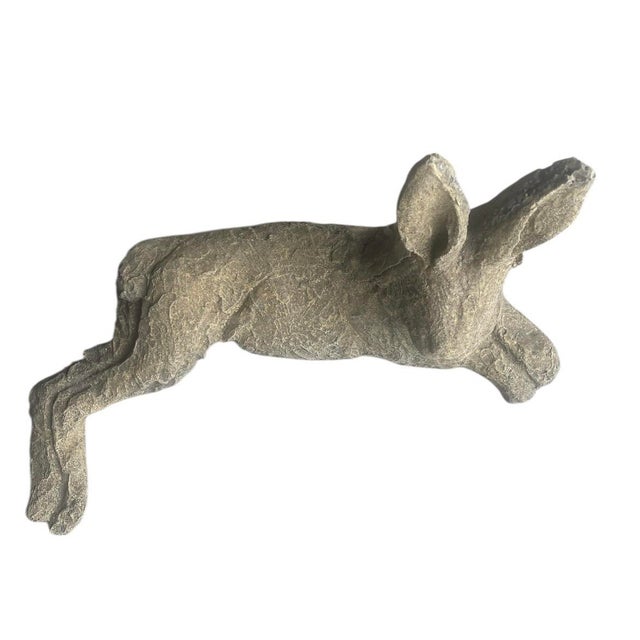 This charming pair of reclining hare statues brings a touch of classic garden whimsy and textured artistry to any space....